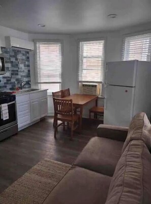 Cozy living space with a kitchenette, dining area, and comfortable seating.