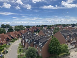 A residential area with terraced houses, a main road, and a clear sky. - Berolina 510 - 90 degrees east - course 90° east - direct view of the Baltic Sea! (Dahme)
