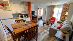A compact living space with a dining area, kitchen, and seating area.