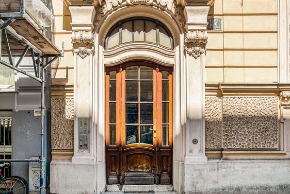 Classic entrance with ornate door, stone carvings, and decorative stonework.