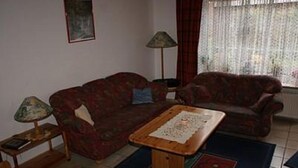 A living room with two sofas, a coffee table, and a lamp.