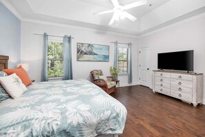 A bedroom with a bed, a television, a dresser, and a window with curtains. - Minutes away from restaurants and activities and c (Saint Simons Island)