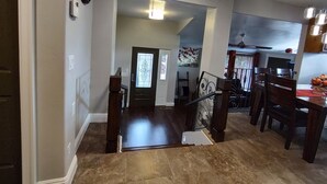 A spacious living area with a staircase leading to a dining area. - The Queen's Respite (A) 2 bedrooms, 2 bathrooms (Toquerville)