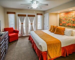 Relax in this inviting space with a large bed, a comfortable armchair, and a dresser.