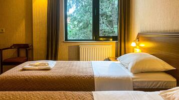 Standard Twin Room | Living area | 24-inch LCD TV with cable channels, TV