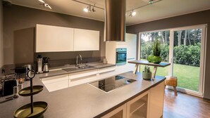 A modern kitchen with a large island, built-in appliances, and a view of the outdoors. - 5 Bedroom Villa in Mendig (Mendig)