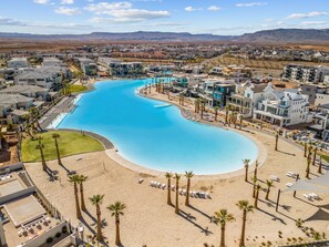 Relax by the pool surrounded by a sandy beach area and enjoy breathtaking views of the distant mountains.