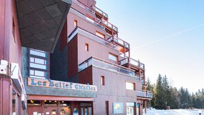 A multi-story building with a sign reading "Les Belles Challes".