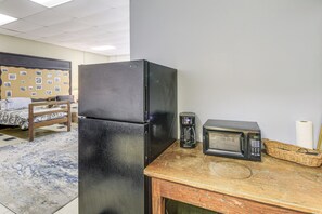 A kitchen with a refrigerator, microwave, coffee maker, and a wicker basket on a wooden countertop. - Access to Warrior Trail! ATV Base Camp in Gary (Gary)