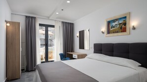 A modern hotel room with a large bed, a desk, a chair, and a balcony with curtains. - Hotel D-Elegant Dubrovnik (Dubrovnik)