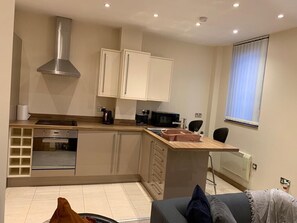 A compact kitchen with modern appliances, a built-in oven, and a microwave. - Executive Apartment a very short walk to the Sunderland metro and train station. (Sunniside)