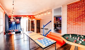 Enjoy games and good company in this spacious room with a pool table, foosball table, and shuffleboard table.