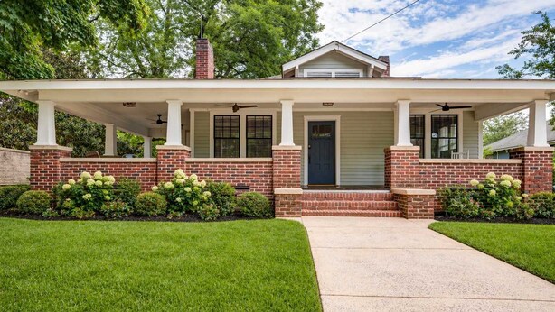 A two-story house with a covered porch, brick exterior, and a front door. - Adorable Home. Close to Everything. Great Location (Charlotte)
