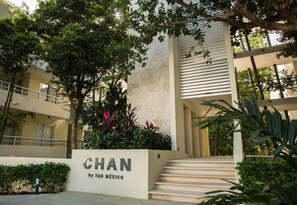 A building entrance with a sign reading "CHAN by TAO MÉXICO". - Stylish Jungle Condo, Walking Distance to Beach (Akumal)