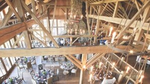 A multi-level wooden structure with tables and chairs arranged on the ground floor, and a staircase connecting the levels. - Hot Tub, Lake Views, Mins to SDC, Pools-Sleeps 16 (Branson)