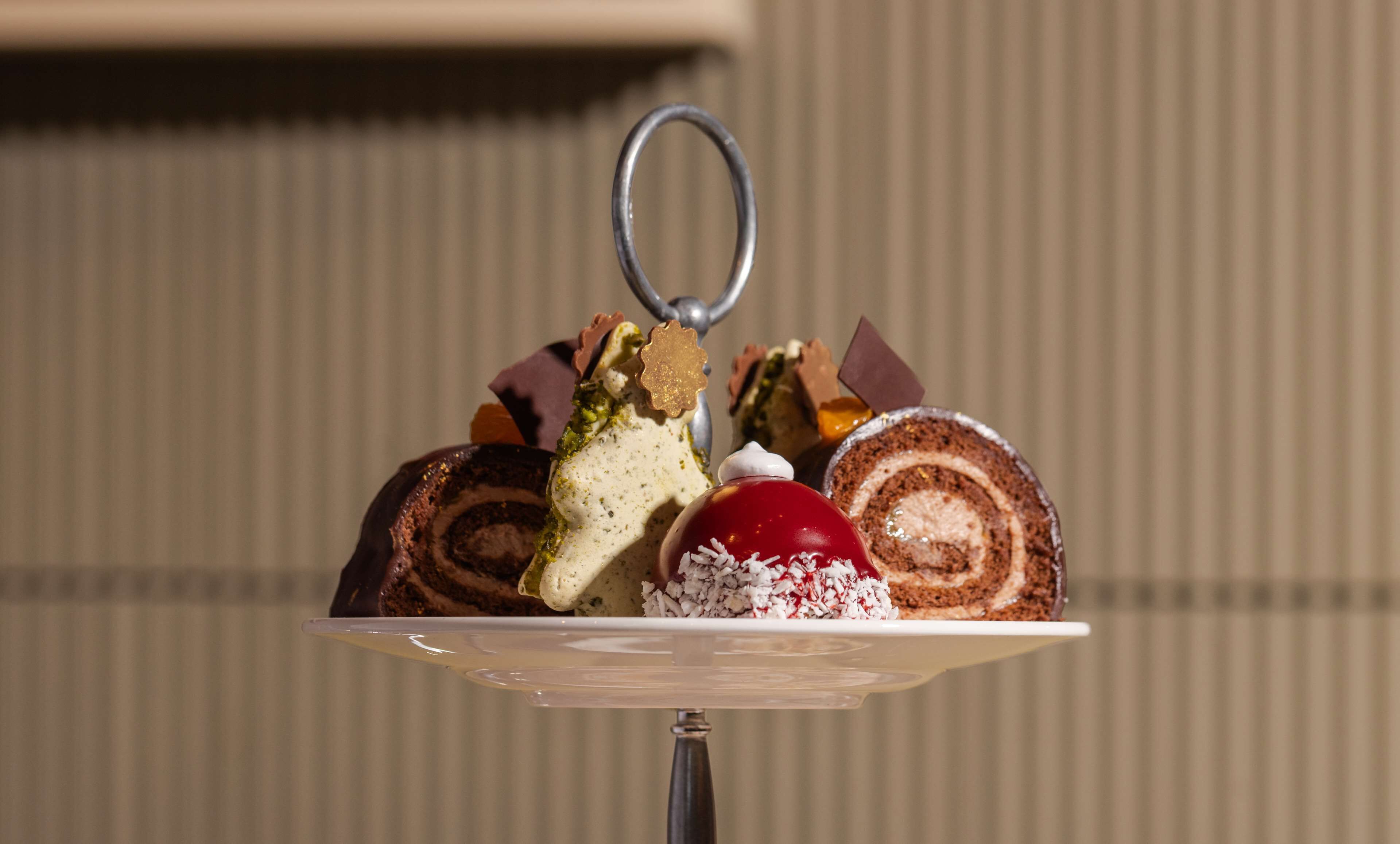 A dessert plate with various sweets and a decorative metal ring.