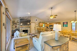 Cozy living area with a fireplace, dining space, and kitchen, perfect for relaxation and socializing.