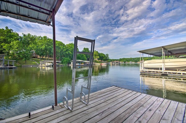 Enjoy serene lakeside views from the covered seating area, where you can relax and take in the tranquil surroundings.