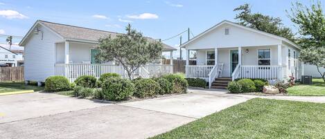 A two-story house with a front porch and a small front yard.