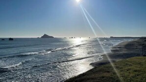 A coastal landscape with a clear sky, calm sea, and distant landforms. - Indoor heated pool ocean views. Fishing short walk away. Pet Friendly!  (Smith River)
