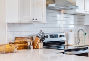 Fridge, dishwasher, coffee/tea maker, cookware/dishes/utensils