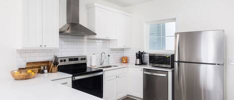 Fridge, dishwasher, coffee/tea maker, cookware/dishes/utensils