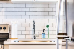 Fridge, dishwasher, coffee/tea maker, cookware/dishes/utensils