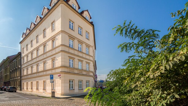 A multi-story building with a classic architectural style, featuring a symmetrical facade with evenly spaced windows and a central entrance. - Minimino hotel (Prague)