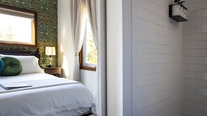 A bedroom with a bed, a nightstand, a lamp, and a window with curtains. - #9 Wonderland Trail Private Bath -Adults only (Packwood)