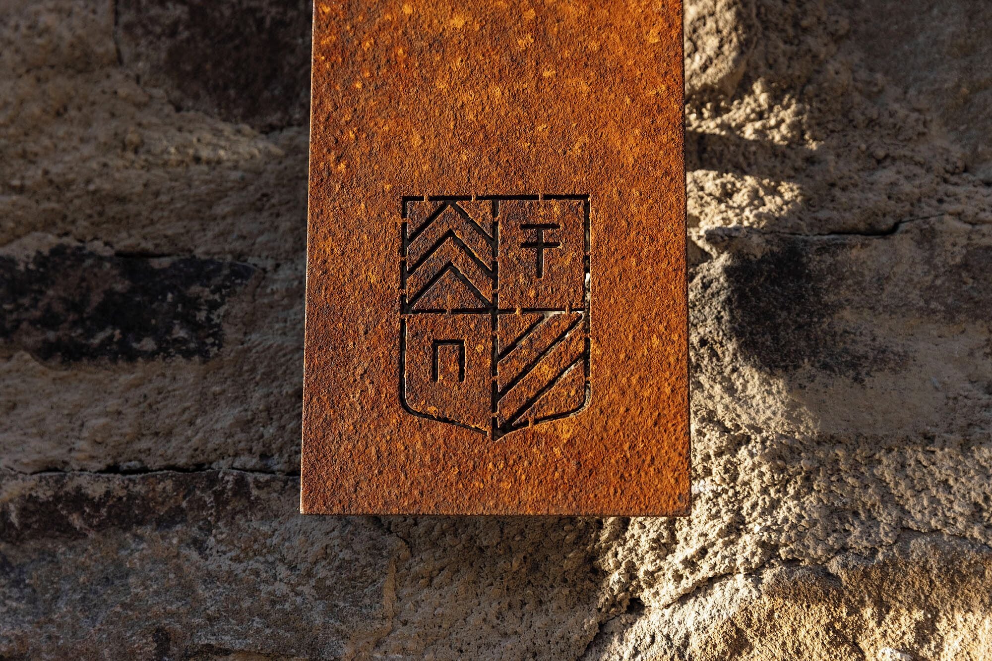 A textured surface with a geometric emblem.
