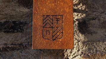 A textured surface with a geometric emblem.
