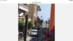 A street view with a pedestrian crossing, a speed limit sign, and a building with a flag. - Carre d or, 50m Mer, Superbe Appart (Nice)