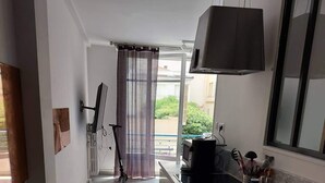 A narrow kitchen with a large window, a microwave, and a sink. - Carre d or, 50m Mer, Superbe Appart (Nice)