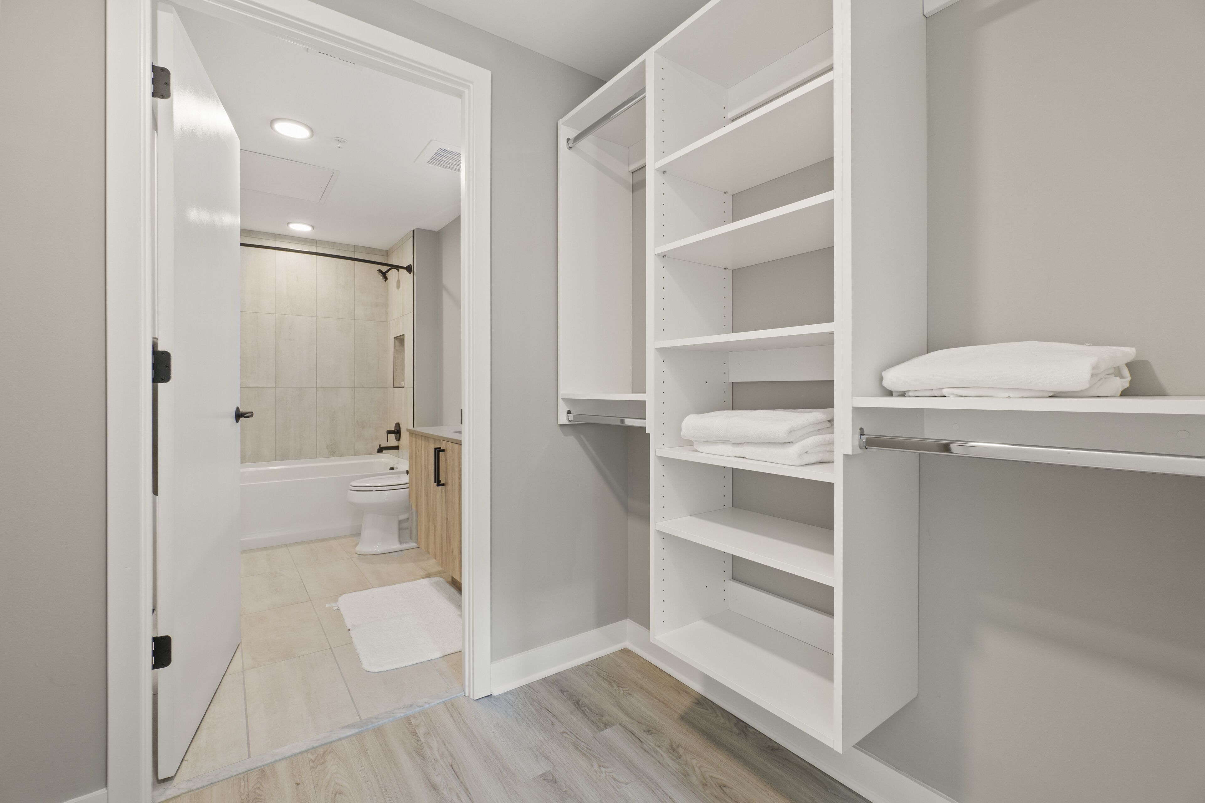 A modern bathroom with a toilet, sink, and shower.