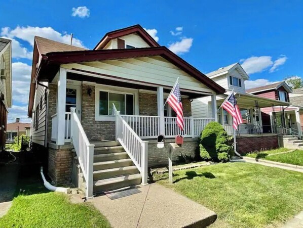 Stunning home with a charming front porch and beautifully manicured lawn.