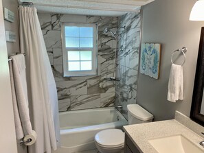 Combined shower/tub, hair dryer, towels, soap