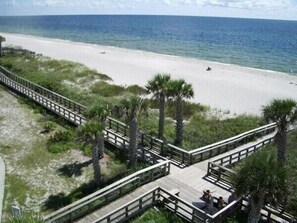 A beach with a wooden boardwalk, palm trees, and a sandy shore. - Newly Listed 1st Floor ground level Condominium, 2 Bed, 2 Bath  Unit 10-101. (Englewood)