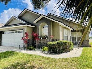 Stylish home with a garage, lush garden, and a clean, contemporary design.