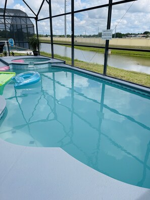 Relax by the pool, surrounded by a serene landscape and a body of water.