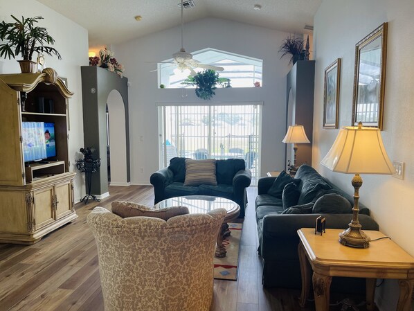 Relax in comfort with ample seating and a warm ambiance, featuring a curved sofa, armchair, and cozy couch.