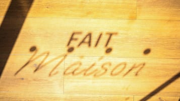 A wooden floor with the name 'Fait Wilson' written on it.
