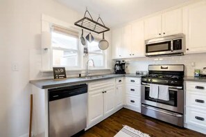 Enjoy cooking in this well-equipped kitchen with a gas stove, oven, microwave, and dishwasher.