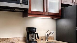 A kitchen with a microwave, coffee maker, sink, and stainless steel refrigerator. - Amazing ocean front studio on the beach at Westin Kaanapali north. (Lahaina)