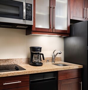 Enjoy cooking in this fully equipped kitchen with a refrigerator, microwave, coffee maker, and dishwasher.