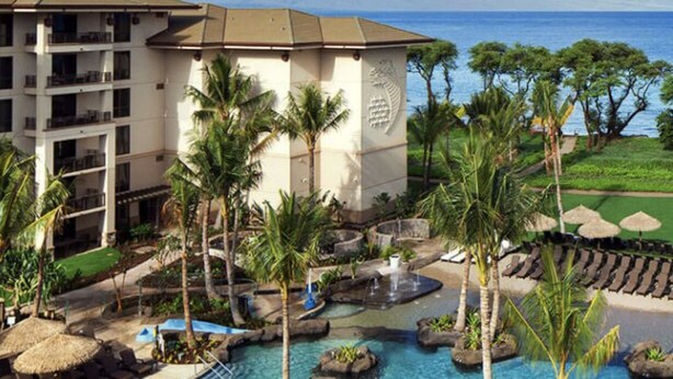 A resort with a pool area, palm trees, and a building with balconies. - Amazing ocean front studio on the beach at Westin Kaanapali north. (Lahaina)