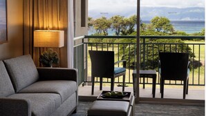 A hotel room with a balcony, a sofa, two chairs, and a table with a fruit bowl. - Amazing ocean front studio on the beach at Westin Kaanapali north. (Lahaina)