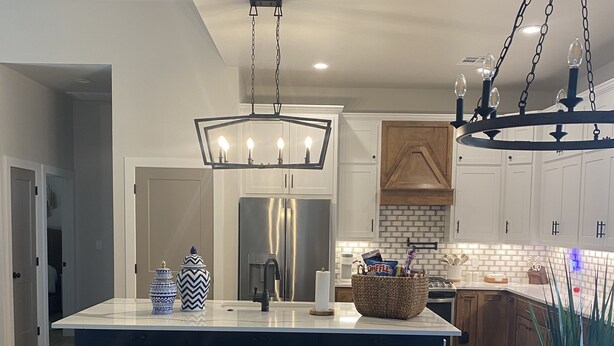 A modern kitchen with a large island, stainless steel appliances, and a hanging light fixture. - “Lake Escape”- Lake House @ Lake of Arbuckle’s (Sulphur)
