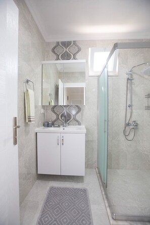 Shower, hair dryer, towels, soap