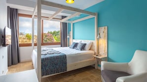 A bedroom with a four-poster bed, a bedside table with a lamp, a chair, and a view of a garden through the window. - Nest Gunay Otel (Kas)
