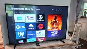 A television on a wooden cabinet with a Roku interface displaying various channels. - Park Ave Peacock in the heart of Cleveland TN (Cleveland)